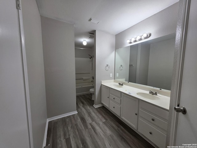 5026 Pine Lk, San Antonio, TX 78244 - bathroom featuring toilet, wood finished floors, a sink, and double vanity