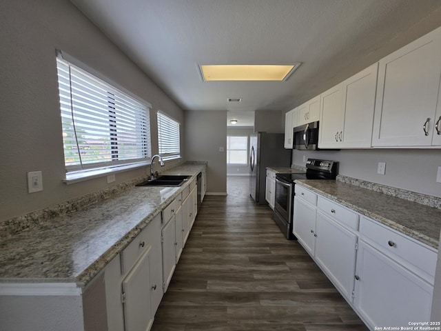 5026 Pine Lk, San Antonio, TX 78244 - kitchen featuring stainless steel appliances, a sink, white cabinetry, and dark wood-style flooring