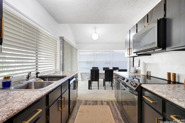 6807 Burnley, San Antonio, TX 78239 - kitchen featuring black electric range oven, vaulted ceiling, a sink, and a textured ceiling