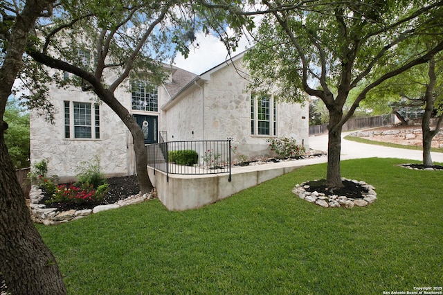 3110 Bonita Spgs, San Antonio, TX 78258 - exterior space with stucco siding, a yard, stone siding, and fence