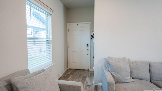 interior space with baseboards and wood finished floors