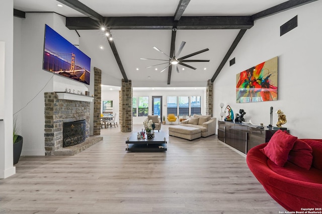living room with high vaulted ceiling, ceiling fan, a fireplace, beam ceiling, and visible vents