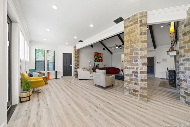 living room with wood finished floors, ornamental molding, lofted ceiling with beams, decorative columns, and ceiling fan