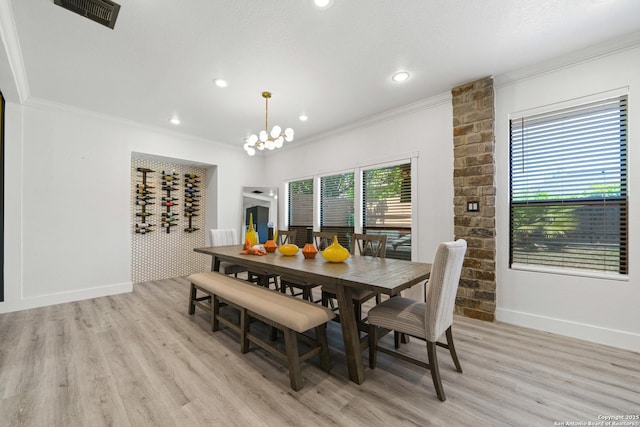 dining space featuring baseboards, ornamental molding, visible vents, and light wood-style flooring
