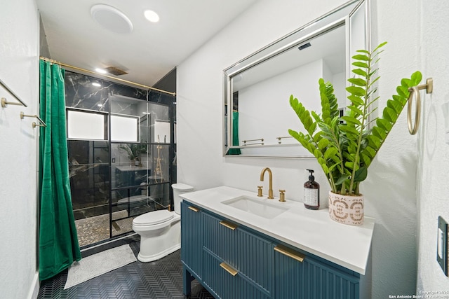 full bath featuring a stall shower, tile patterned floors, vanity, and toilet