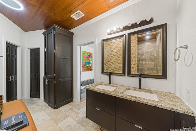 bathroom featuring wooden ceiling, visible vents, a sink, and crown molding