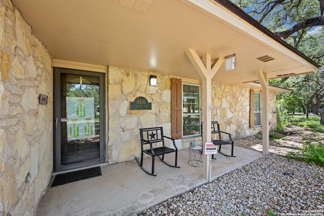9416 Geronimo Vw, San Antonio, TX 78254 - view of exterior entry featuring stone siding and a porch