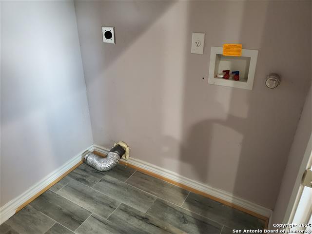 laundry room featuring baseboards, laundry area, hookup for an electric dryer, and hookup for a washing machine