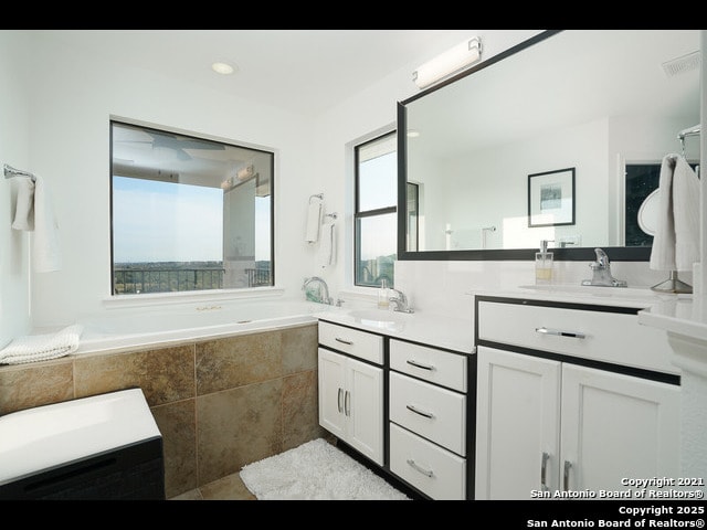 full bathroom featuring tile patterned flooring, vanity, and visible vents