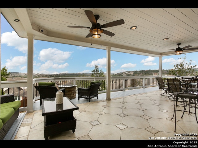 view of patio with outdoor dining space and ceiling fan