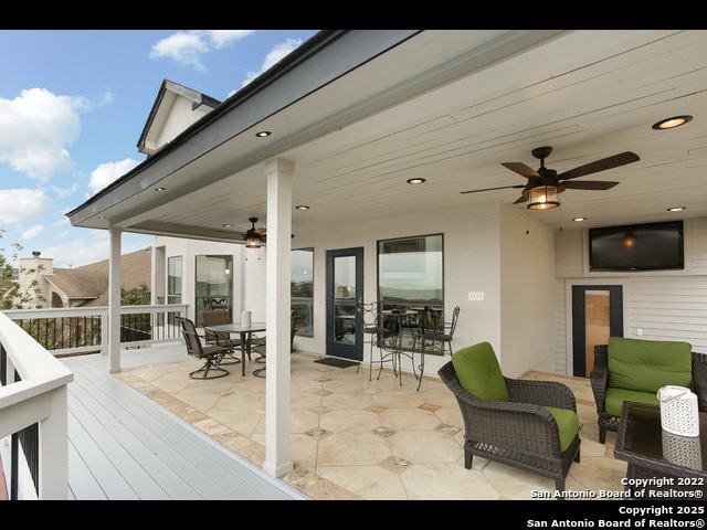 deck featuring outdoor lounge area, outdoor dining space, and a ceiling fan