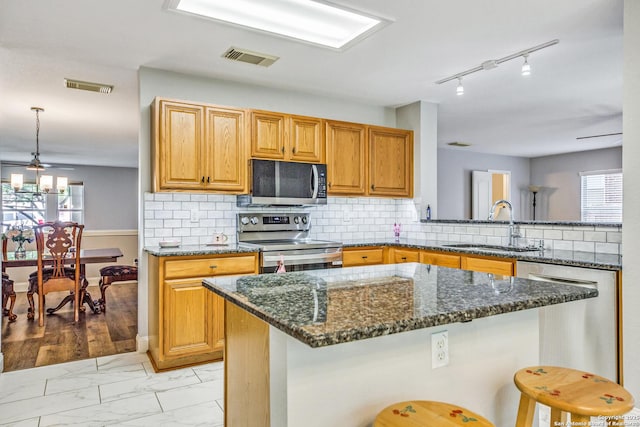 kitchen with a healthy amount of sunlight, stainless steel appliances, visible vents, and a sink