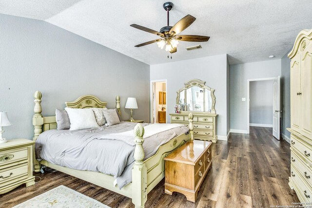 bedroom featuring dark wood-type flooring, a textured ceiling, and visible vents
