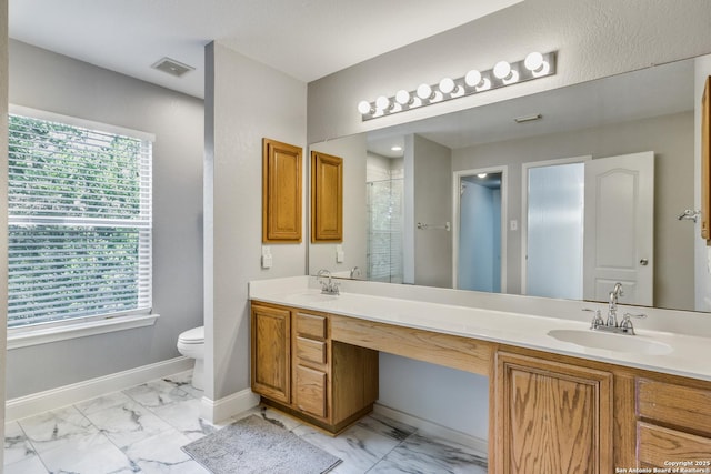 bathroom featuring visible vents, a sink, marble finish floor, and toilet