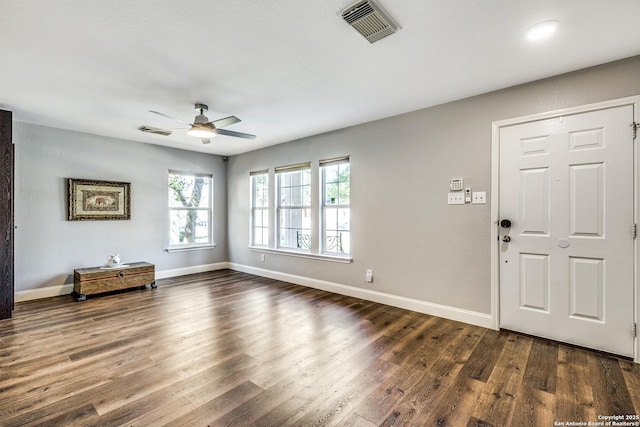 entryway featuring dark wood-style floors, baseboards, ceiling fan, and visible vents