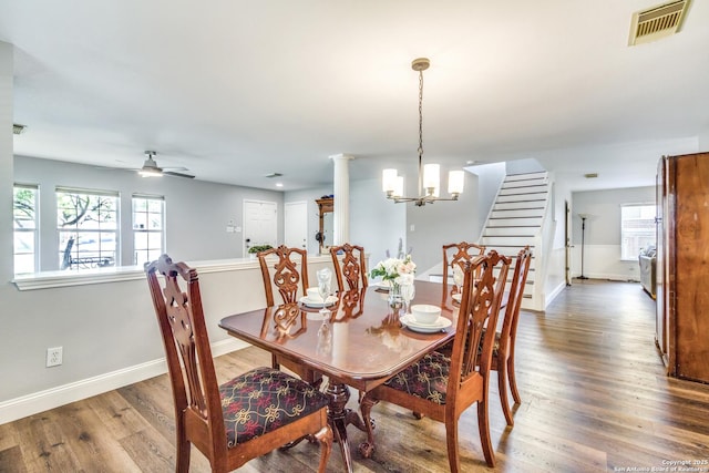 dining room with baseboards, wood finished floors, visible vents, and a wealth of natural light