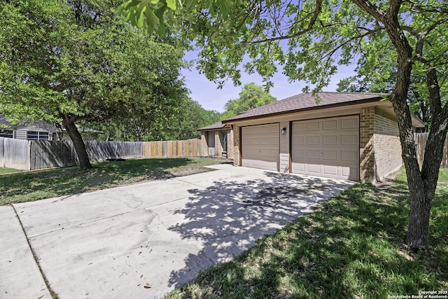 9400 Woodland Hls, San Antonio, TX 78250 - view of front of house with fence, a front lawn, driveway, and brick siding