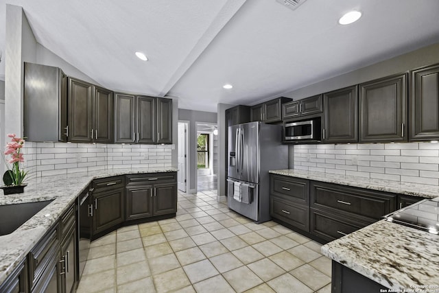 9400 Woodland Hls, San Antonio, TX 78250 - kitchen with tasteful backsplash, light tile patterned floors, appliances with stainless steel finishes, light stone countertops, and recessed lighting