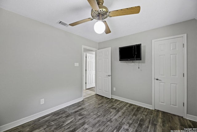 9400 Woodland Hls, San Antonio, TX 78250 - unfurnished bedroom with wood finished floors, visible vents, a ceiling fan, and baseboards