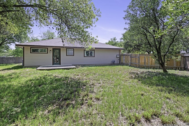 9400 Woodland Hls, San Antonio, TX 78250 - rear view of property featuring a wooden deck, a lawn, a shingled roof, and a fenced backyard