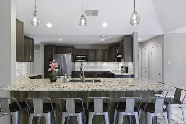 9400 Woodland Hls, San Antonio, TX 78250 - kitchen with backsplash, visible vents, stainless steel appliances, and a sink