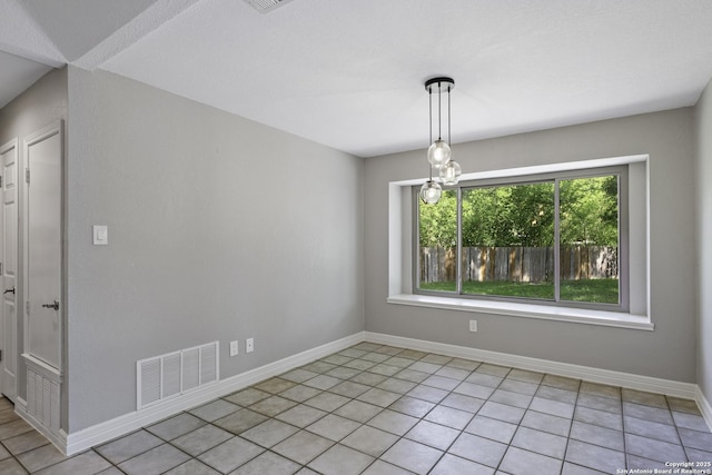 9400 Woodland Hls, San Antonio, TX 78250 - unfurnished dining area with baseboards, visible vents, and light tile patterned floors