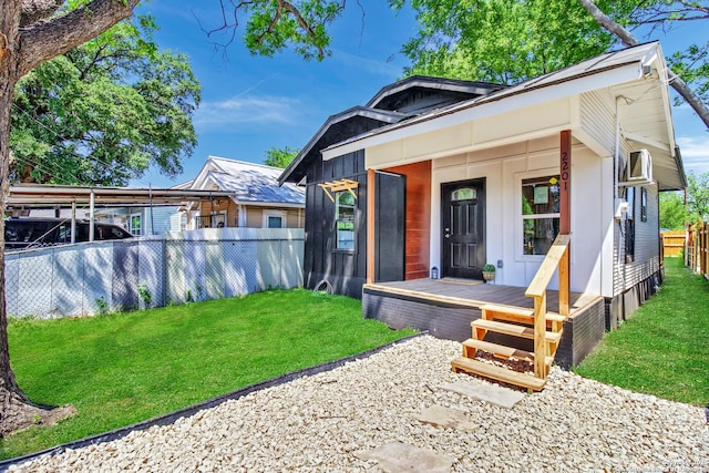 2201 San Fernando, San Antonio, TX 78207 - view of front of house featuring fence, board and batten siding, a porch, a front yard, and a carport