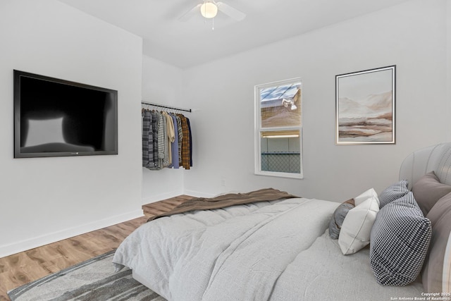 2201 San Fernando, San Antonio, TX 78207 - bedroom featuring baseboards, a ceiling fan, and wood finished floors