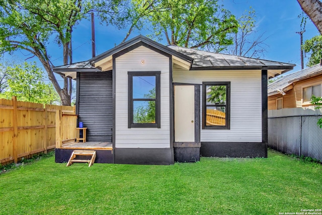 2201 San Fernando, San Antonio, TX 78207 - back of property with a lawn and a fenced backyard