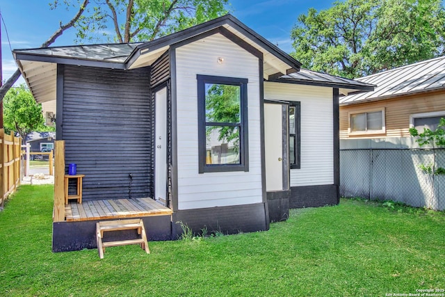 2201 San Fernando, San Antonio, TX 78207 - back of property with metal roof, a yard, a standing seam roof, and fence