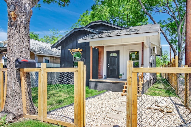 2201 San Fernando, San Antonio, TX 78207 - view of front of home with board and batten siding, fence private yard, a standing seam roof, and a gate