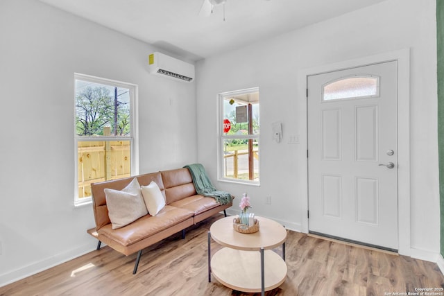 2201 San Fernando, San Antonio, TX 78207 - living area with a wall mounted AC, light wood-type flooring, a ceiling fan, and baseboards