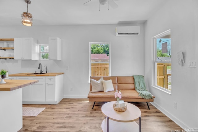 2201 San Fernando, San Antonio, TX 78207 - living area with a ceiling fan, a healthy amount of sunlight, and a wall unit AC