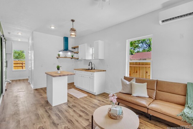 2201 San Fernando, San Antonio, TX 78207 - living room with recessed lighting, light wood-type flooring, an AC wall unit, and baseboards