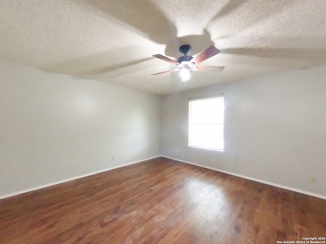 empty room with wood finished floors, baseboards, a textured ceiling, and ceiling fan