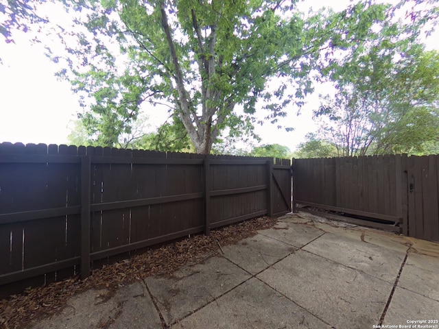 view of patio with a gate and fence