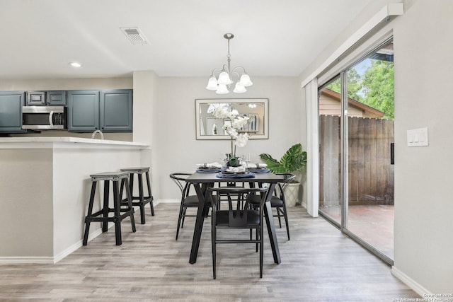 3654 Candlehead, San Antonio, TX 78244 - dining area featuring light wood-style flooring, baseboards, visible vents, recessed lighting, and a notable chandelier