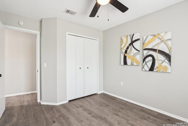 3654 Candlehead, San Antonio, TX 78244 - unfurnished bedroom featuring baseboards, visible vents, a ceiling fan, wood finished floors, and a closet