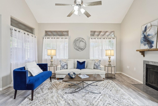 3654 Candlehead, San Antonio, TX 78244 - living room featuring lofted ceiling, wood finished floors, a ceiling fan, a premium fireplace, and baseboards