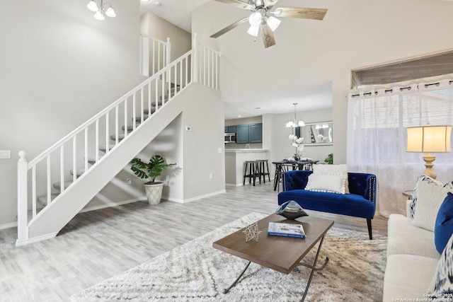 3654 Candlehead, San Antonio, TX 78244 - living area with stairway, baseboards, wood finished floors, and ceiling fan with notable chandelier
