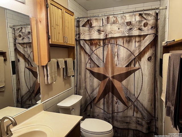 bathroom with toilet and vanity
