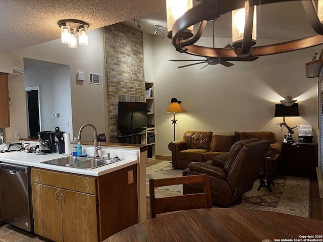 kitchen featuring open floor plan, stainless steel dishwasher, visible vents, and a sink