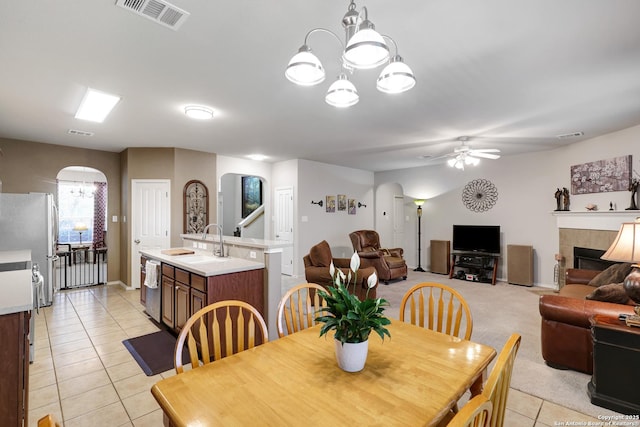 711 Point Spgs, San Antonio, TX 78253 - dining area featuring light tile patterned flooring, visible vents, ceiling fan with notable chandelier, and arched walkways