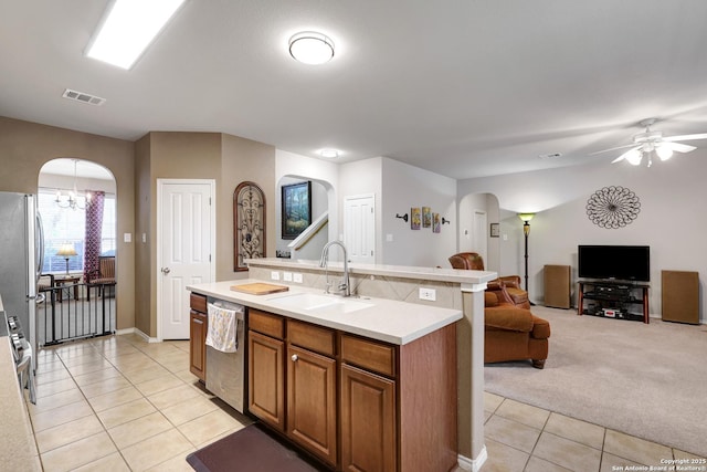 711 Point Spgs, San Antonio, TX 78253 - kitchen featuring stainless steel dishwasher, a sink, visible vents, arched walkways, and light tile patterned flooring