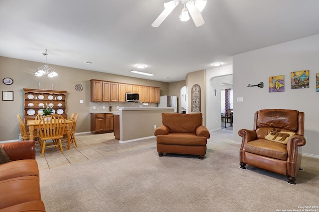 711 Point Spgs, San Antonio, TX 78253 - living room featuring baseboards, a ceiling fan, light tile patterned flooring, and light colored carpet