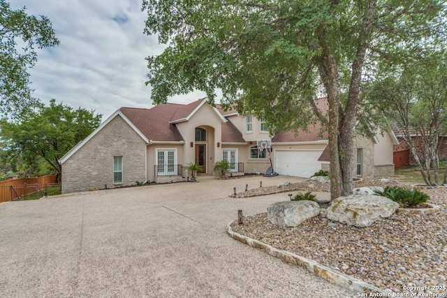 19111 Nature Oaks, San Antonio, TX 78258 - traditional home featuring fence, stucco siding, an attached garage, concrete driveway, and french doors