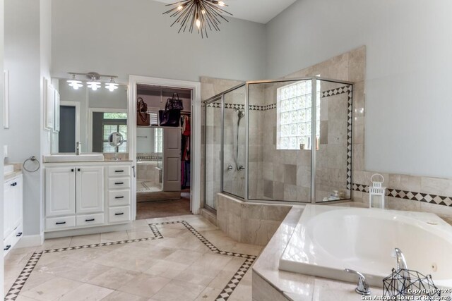 19111 Nature Oaks, San Antonio, TX 78258 - bathroom featuring a bath, a chandelier, vanity, and a shower stall