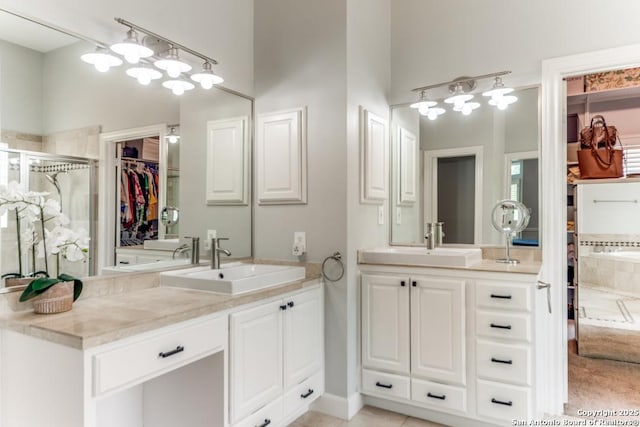 19111 Nature Oaks, San Antonio, TX 78258 - bathroom with two vanities, a spacious closet, a stall shower, and a sink