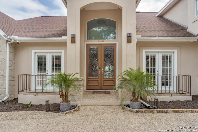 19111 Nature Oaks, San Antonio, TX 78258 - property entrance featuring stucco siding, roof with shingles, and french doors