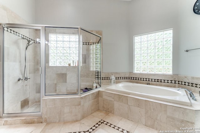 19111 Nature Oaks, San Antonio, TX 78258 - bathroom featuring a bath, tile patterned flooring, and a stall shower